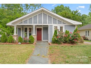 Charming home with a stone walkway, attractive landscaping, and a red front door at 222 N Weldon St, Gastonia, NC 28052
