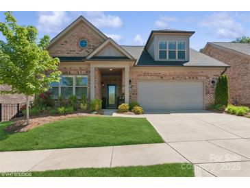 Charming brick home boasts manicured lawn and a two-car garage at 3006 Portico Pl # 37, Fort Mill, SC 29715