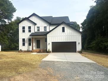 Charming, modern farmhouse with white siding, black trim, and a spacious two-car garage at 3114 Ansonville Rd, Marshville, NC 28103