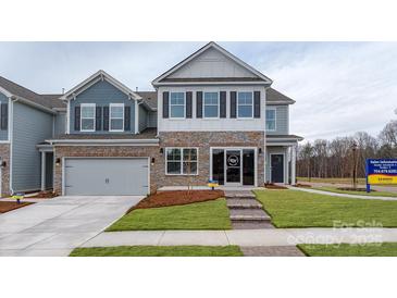 Charming two-story home with stone accents, a two-car garage, and manicured lawn at 4210 Steel Way, Sherrills Ford, NC 28673