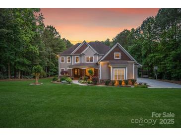 Stunning two-story home with a manicured lawn and inviting curb appeal at 4877 River Hills Dr, Denver, NC 28037