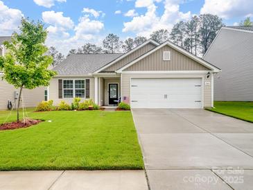 Charming single-story home featuring a well-manicured lawn, two-car garage, and inviting curb appeal at 584 Lamorak Pl, Richburg, SC 29729