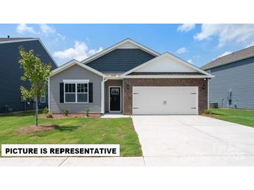 Charming single-Gathering home with a mix of brick and siding, complemented by a well-manicured front lawn at 105 Way Cross Ln, Troutman, NC 28166