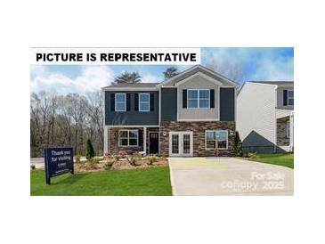 New construction home showcasing a two-story layout, stone accents, and manicured front lawn at 129 Way Cross Ln, Troutman, NC 28166
