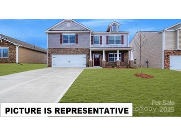 Charming two-story home showcasing a well-manicured lawn and a classic brick and siding exterior at 143 Way Cross Ln, Troutman, NC 28166