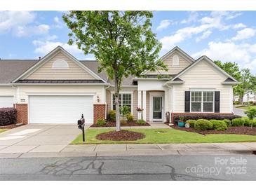 Charming single-story home featuring a well-manicured lawn and inviting front porch, perfect for relaxing at 31470 Royal Tern Ln, Indian Land, SC 29707