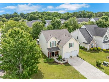 Charming two-story home featuring a well-manicured lawn, lush landscaping, and a two-car garage at 544 Cool Creek Dr, Rock Hill, SC 29732