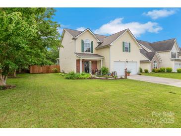 Charming two-story home featuring a well-manicured lawn, lush landscaping, and a welcoming front porch at 544 Cool Creek Dr, Rock Hill, SC 29732