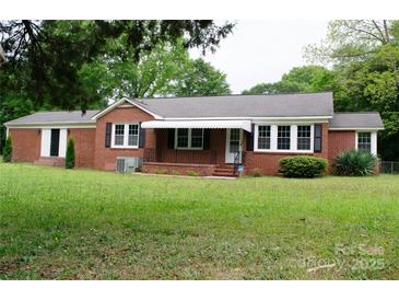 Charming brick home with a well-maintained lawn and classic black shutters at 925 Grace Ave, Lancaster, SC 29720