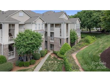 Condominium exterior with brick accents, lush landscaping and private balconies at 108 Pier 33 Dr # 414, Mooresville, NC 28117