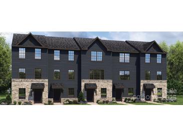 Charming townhome exterior showcasing a brick foundation and dark siding at 1430 Samuel St, Charlotte, NC 28206