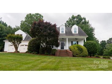 Charming two-story traditional style home with well-manicured lawn and manicured landscaping at 19523 Sunnypoint Ct, Cornelius, NC 28031