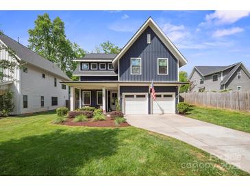 Charming two-story home with a well-manicured lawn and a two-car garage at 2637 Springway Dr, Charlotte, NC 28205