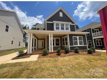 Beautiful exterior of this two-story home featuring a covered porch with stylish curb appeal at 4029 Grommet Ct, Matthews, NC 28105