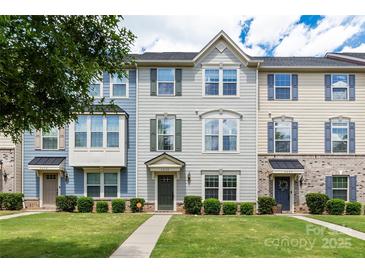 Attractive townhouse showcasing a manicured lawn and inviting entrance with muted colors and natural light at 4038 Zilker Park Dr, Charlotte, NC 28217