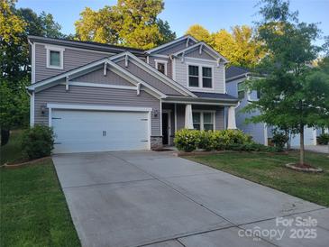 Charming two-story home boasts manicured lawn and attached two-car garage at 5031 Burnwald Ct, Fort Mill, SC 29715