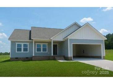 Charming single-story home with attached garage, lush lawn, and inviting curb appeal at 6203 Flay Rd, Cherryville, NC 28021