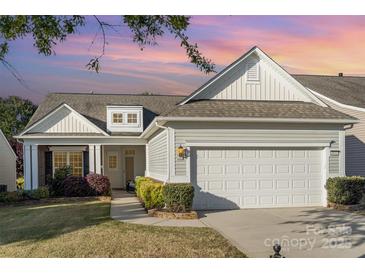 Charming home with a two-car garage, manicured landscaping, and a welcoming front porch at 8033 Pawleys Ct, Fort Mill, SC 29707
