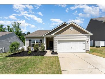 Charming single-story home featuring a well-manicured lawn, a two car garage, and pleasant curb appeal at 8316 Highgate Dr, Charlotte, NC 28215