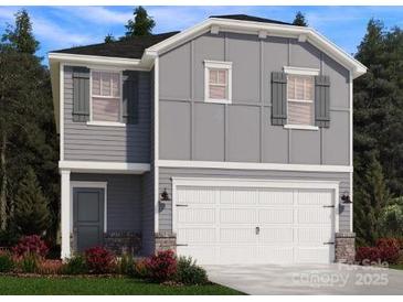 Charming two-story home featuring a two-car garage, gray siding, and shuttered windows at 1425 Wildflower St, Newton, NC 28658