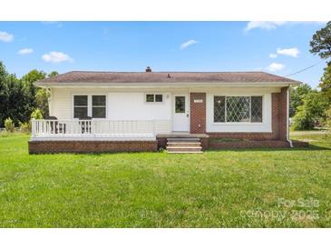 Charming single-story home with a well-manicured lawn, brick accents, and a cozy front porch at 1725 Fallston Rd, Shelby, NC 28150