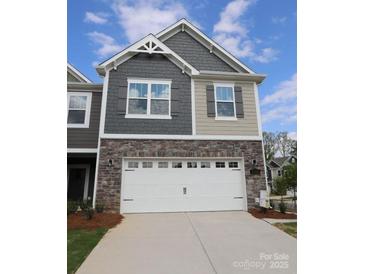 Charming two-story home with stone accents and a two-car garage at 3156 Lilac Grove Dr, Charlotte, NC 28269