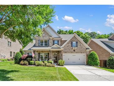 Charming two-story brick home with manicured lawn and welcoming front porch at 9075 Blue Ridge Dr, Indian Land, SC 29707