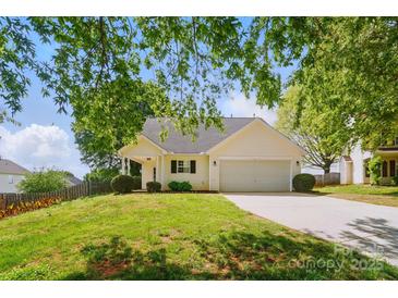 Charming home featuring a manicured front lawn and an attached two-car garage at 9711 Castle Terrace Ct, Charlotte, NC 28215