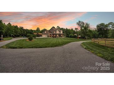 Stunning two-story home showcasing meticulously manicured landscaping and a lengthy driveway leading to the property at 3440 17Th Ne Ave, Hickory, NC 28601