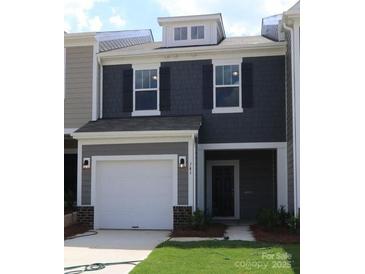 Charming two-story home with gray siding, white trim, garage, and manicured lawn at 746 Lockhaven Nw Dr, Concord, NC 28027