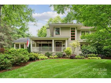 Charming home featuring a covered porch, lush landscaping, and a well-manicured lawn at 920 Habersham Dr, Charlotte, NC 28209