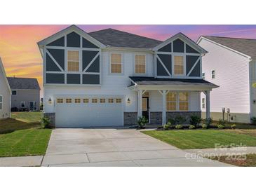 Inviting two-story home with a two-car garage, craftsman architecture, and manicured lawn at 2021 Boynton St, Charlotte, NC 28269