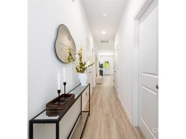 Bright hallway featuring a console table with mirror, décor and stylish flooring at 220 S Columbia St, Gastonia, NC 28054