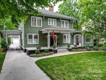 Charming two-story home with a welcoming front porch, lush landscaping, and inviting curb appeal at 226 Union S St, Concord, NC 28025