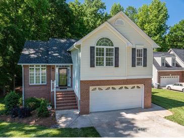 Charming two-story home features a brick and siding exterior, attached garage, and well-maintained lawn at 319 Beacon Hills Dr, Gastonia, NC 28056