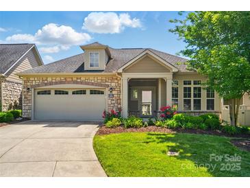 Charming single-Gathering home boasts a stone and siding exterior, well-manicured lawn, and a two-car garage at 5028 Polo Gate Blvd, Charlotte, NC 28216