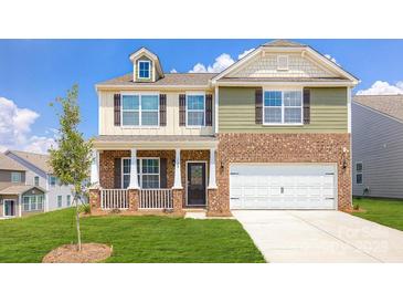 Charming two-story home with a well-manicured lawn, inviting front porch, and a two-car garage at 545 Stroupe Rd, Gastonia, NC 28056