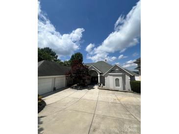 Charming home featuring an attached two car garage, with a well-manicured front yard and inviting entrance at 16108 Woolwine Rd, Charlotte, NC 28278