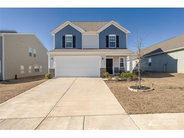 Charming two-story home featuring a two-car garage, blue and white siding, and a well-maintained front yard at 2754 Legacy Ridge Ln, Catawba, NC 28609