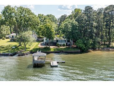Stunning lakefront property featuring a private pier and lush greenery, offering a serene retreat at 9115 Clement Cir, Terrell, NC 28682