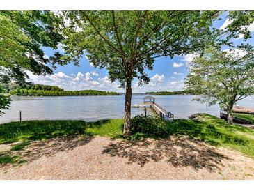 Lush backyard with mature trees leading to a private dock and lake access at 9115 Clement Cir, Terrell, NC 28682