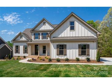 Beautiful home featuring a bright white exterior, charming brown shutters, and a well-manicured front yard at 104. Wilharr Ct # 40, Mooresville, NC 28115