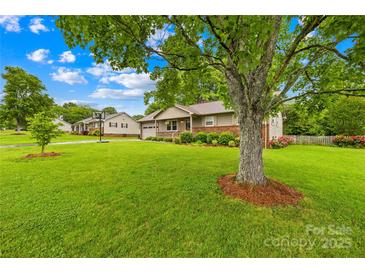 Charming single-story home with well-maintained lawn, tree, and cozy front porch at 117 Ethel Ln, Statesville, NC 28625
