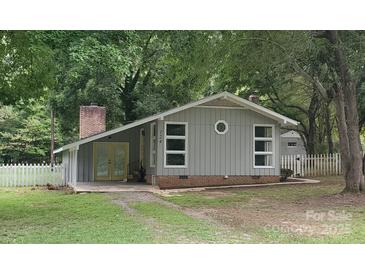 Charming single-story home features a well-maintained lawn and traditional architectural details at 124 Roxie Ln, Belmont, NC 28012