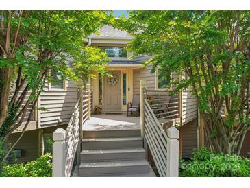 Inviting front porch of home with chairs, railing, plants and a wreath on the front door at 14118 Yachtsman Harbor Dr, Charlotte, NC 28278