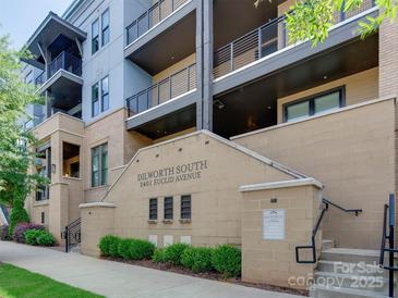 Stylish condo building with multi-story balconies, brick facade and well-maintained landscaping at 2401 Euclid Ave # 207, Charlotte, NC 28203