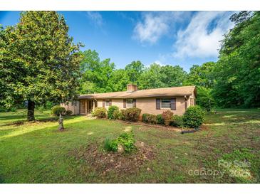 Charming brick home featuring well-maintained landscaping and a lush green lawn at 2871 Loviee Rd, Lincolnton, NC 28092
