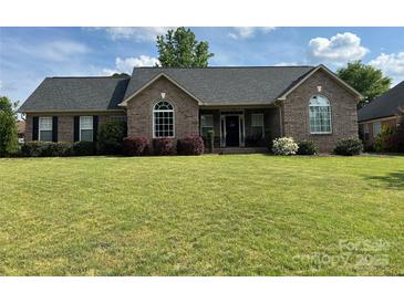 Charming single-story brick home with a well-manicured lawn and mature landscaping at 334 River Birch Cir, Mooresville, NC 28115