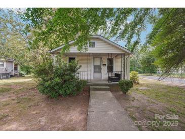Charming one-story home with vinyl siding, front porch and well-maintained landscaping at 409 Rosemont Ave, Kannapolis, NC 28081