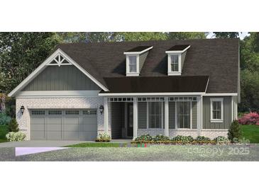 Charming single-story home with a gray brick facade, attached two-car garage and a covered front porch at 4444 Moxie Way, Charlotte, NC 28215
